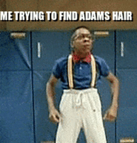 A Man Wearing Suspenders Is Standing In Front Of A Blue Wall With The Words Me Trying To Find Adams Hair Above Him GIF
