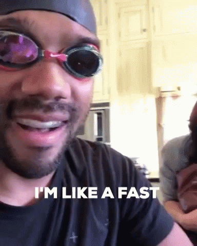 A Man Wearing Swim Goggles And A Swim Cap Says I 'M Like A Fast GIF