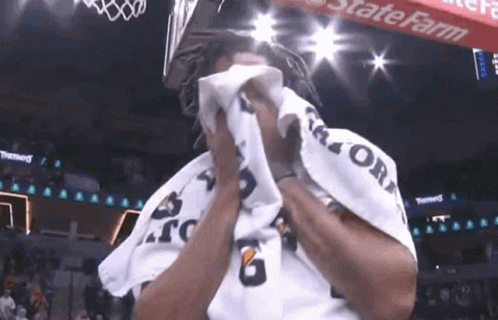 A Man Wipes His Face With A Gatorade Towel GIF
