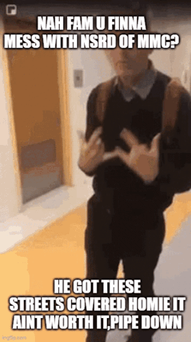 A Man With A Backpack Is Standing In A Hallway And Making A Funny Face GIF
