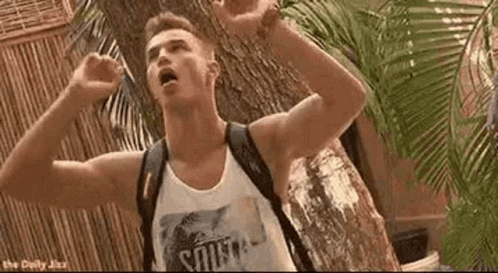 A Man With A Backpack Is Standing In Front Of A Tree . GIF