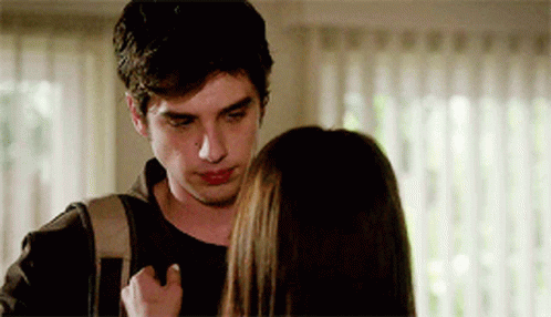 A Man With A Backpack Looks At A Woman GIF