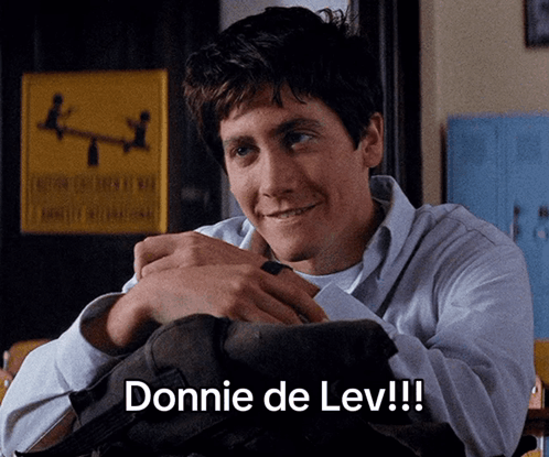 A Man With A Backpack On His Lap Says Donnie De Lev GIF