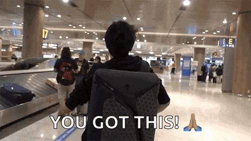 A Man With A Backpack Walking Through An Airport With The Words " You Got This " On The Bottom GIF
