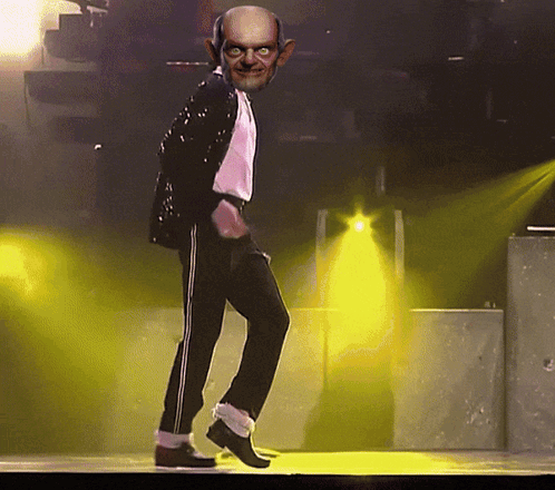 Bald Man Dancing On Stage With Yellow Lights GIF