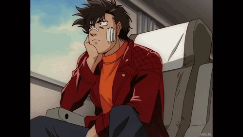 A Man With A Bandage On His Face Is Sitting In A Chair With His Hand On His Chin GIF