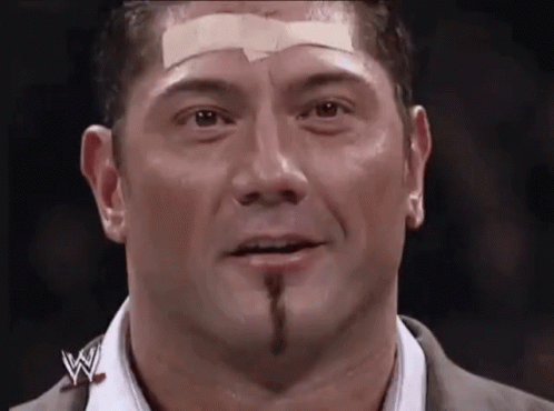 A Man With A Bandage On His Forehead And A W Logo On His Shirt GIF