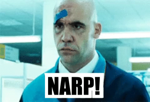 A Man With A Bandage On His Forehead Is Standing In A Room With The Word Narp . GIF