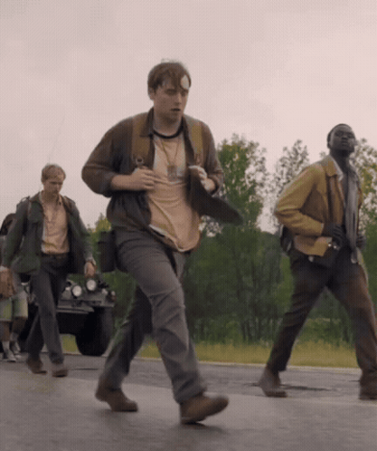 A Man With A Bandage On His Head Is Running Down The Road GIF