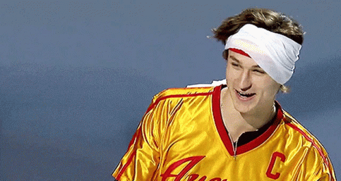 A Man With A Bandage On His Head Wears A Yellow Jersey With The Letter C On The Front GIF