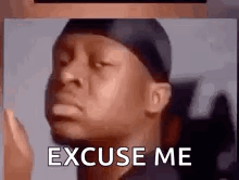 A Man With A Bandana On His Head Is Making A Funny Face And Says `` Excuse Me '' . GIF