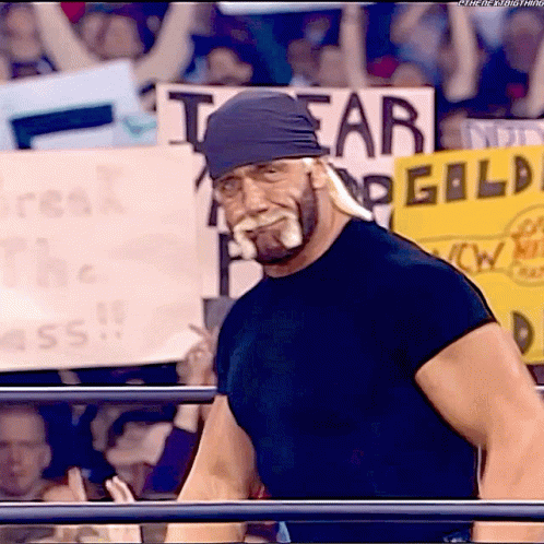 A Man With A Bandana On His Head Stands In Front Of A Sign That Says I Fear Gild GIF