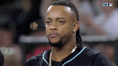 A Man With A Beard And A Black Shirt Is Watching A Baseball Game On Fox . GIF