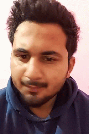A Man With A Beard And A Blue Shirt Is Smiling GIF
