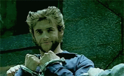 A Man With A Beard And A Blue Shirt Is Wearing Handcuffs GIF