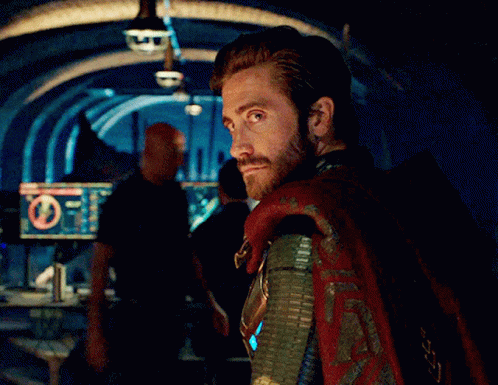 A Man With A Beard And A Cape Is Standing In Front Of A Computer Monitor With A Circle In The Middle GIF