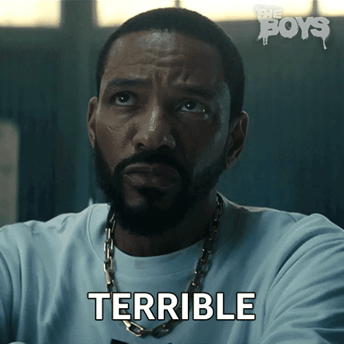 A Man With A Beard And A Chain Around His Neck Says Terrible GIF