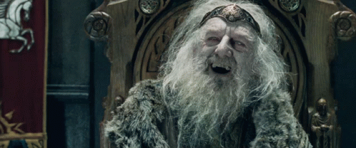 A Man With A Beard And A Crown On His Head Sits On A Throne GIF