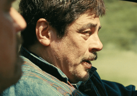 A Man With A Beard And A Denim Shirt Is Talking To Another Man GIF