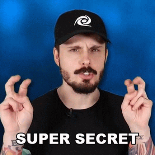 A Man With A Beard And A Hat Is Making A Super Secret Gesture With His Fingers . GIF