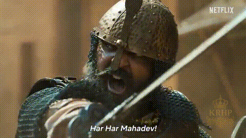 A Man With A Beard And A Helmet Is Holding A Sword And Shouting . GIF