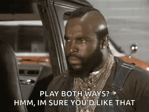 A Man With A Beard And A Mohawk Is Sitting In A Car And Talking . GIF