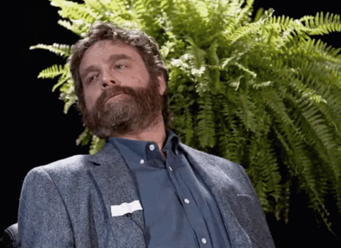 a man with a beard and a name tag on his pocket