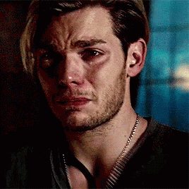 A Man With A Beard And A Necklace Is Crying . GIF