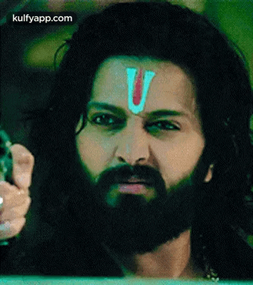 A Man With A Beard And A Red Letter V On His Forehead . GIF