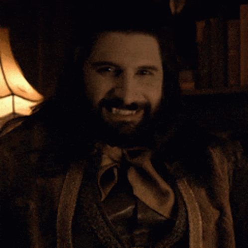 A Man With A Beard And A Ring On His Finger Is Smiling GIF