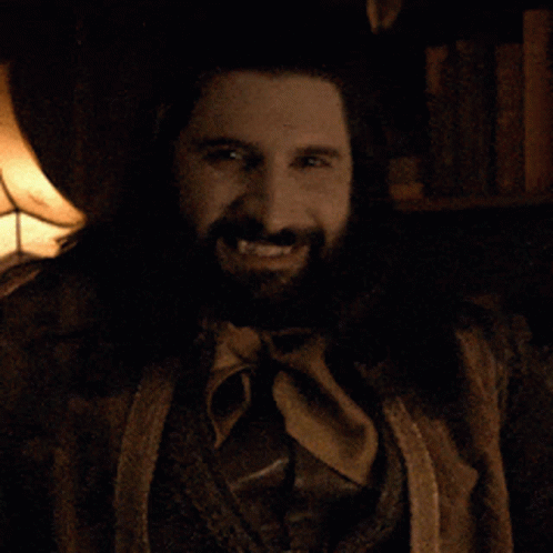 A Man With A Beard And A Ring On His Finger Smiles For The Camera GIF