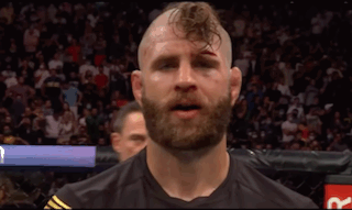 A Man With A Beard And A Shaved Head Has A Black Shirt On GIF