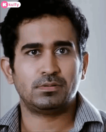 A Man With A Beard And A Striped Shirt Is Looking At The Camera With A Surprised Look On His Face . GIF