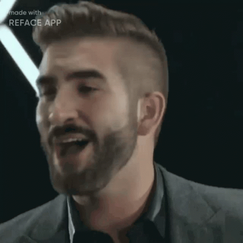 A Man With A Beard And A Suit Is Made With Reface App GIF