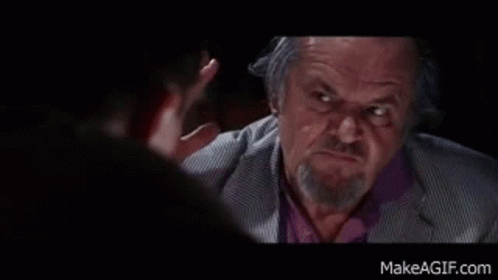 A Man With A Beard And A Suit Is Talking To Another Man . GIF
