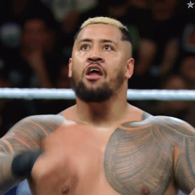 A Man With A Beard And A Tattoo On His Chest Is Standing In A Boxing Ring GIF