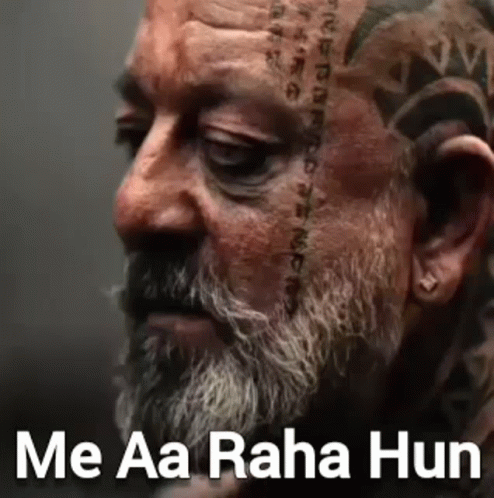 A Man With A Beard And A Tattoo On His Face . GIF