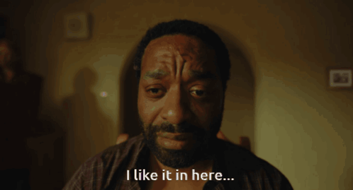 a man with a beard and a tattoo on his forehead says i like it in here