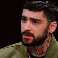 A Man With A Beard And A Tattoo On His Neck Has The Number 5 On It GIF