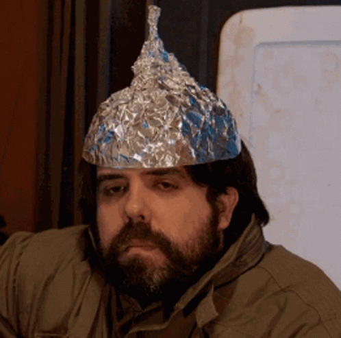 A Man With A Beard And A Tin Foil Hat On His Head GIF