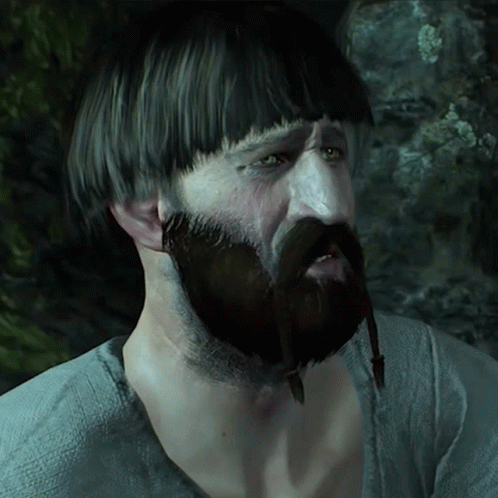 A Man With A Beard And A Very Short Haircut Has A Necklace Around His Neck GIF