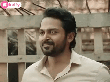 A Man With A Beard And A White Shirt Is Smiling . GIF