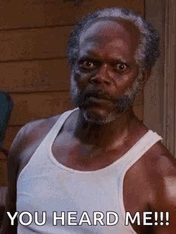 A Man With A Beard And A White Tank Top Is Saying `` You Heard Me ! '' GIF