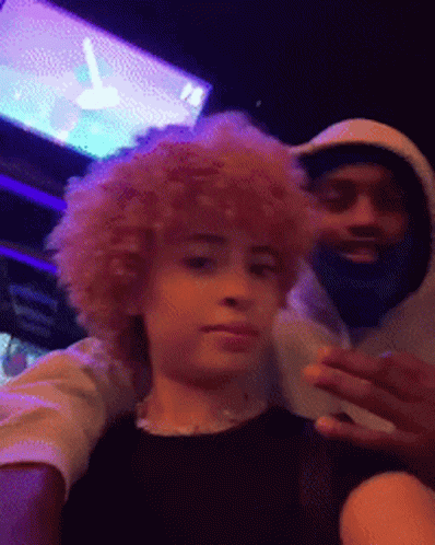 A Man With A Beard And A Woman With Curly Hair Are Posing For A Picture Together . GIF