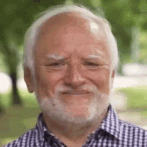 A Man With A Beard And Bald Head Is Smiling . GIF