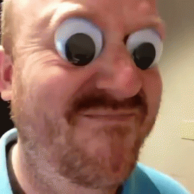 A Man With A Beard And Big Googly Eyes Is Making A Face . GIF