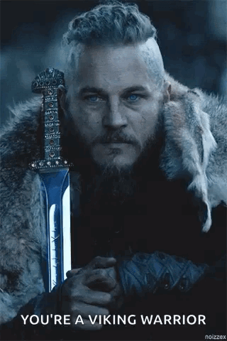 A Man With A Beard And Blue Eyes Is Holding A Sword And Says `` You 'Re A Viking Warrior '' . GIF