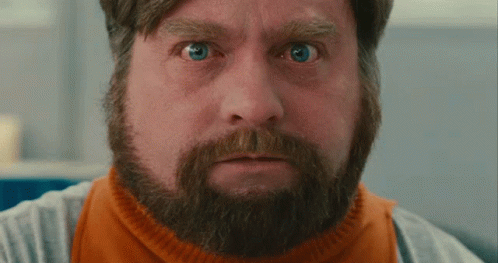 A Man With A Beard And Blue Eyes Is Making A Funny Face GIF