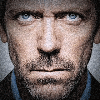A Man With A Beard And Blue Eyes Looks At The Camera GIF