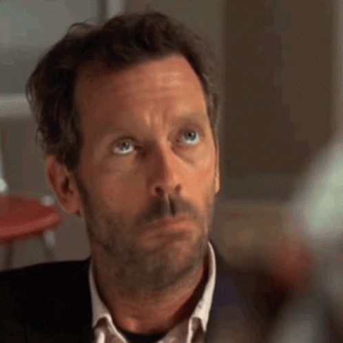 A Man With A Beard And Blue Eyes Looks Up At Something GIF